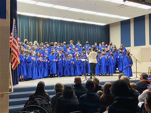 Students on stage singing at a Chorus concert.